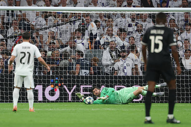 Real Madrid vs Juventus Review: Thibaut Courtois makes a save during the UEFA Champions League 2025/26 League Phase MD3 match between Real Madrid and Juventus at the Bernabeu on October 22, 2025.