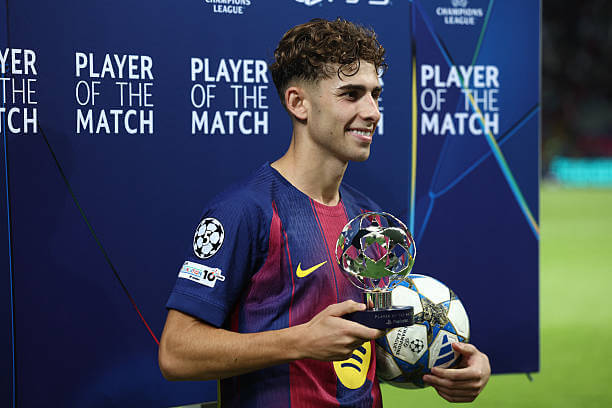 Barcelona vs Olympiacos Review: Fermin Lopez smiles holding up the player of the match trophy after scoring a hat-trick in the UEFA Champions League 2025/26 League Phase MD3 match between Barcelona and Olympiacos at the Estadi Olimpic Lluis Companys on October 21, 2025.