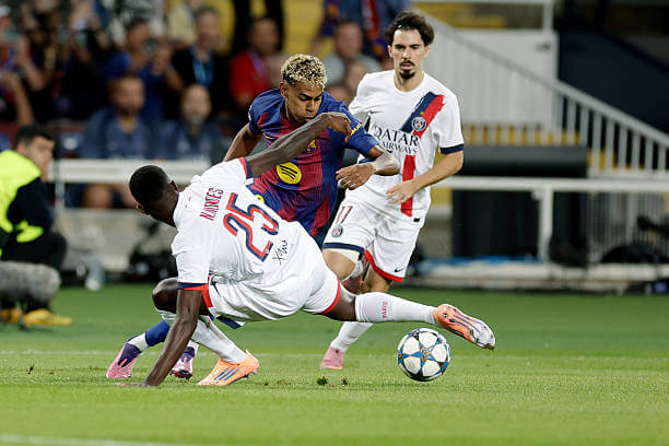 Barcelona vs PSG Review: Lamine Yamal runs with the ball whilst under pressure from Nuno Mendes during the UEFA Champions League 2025/26 League Phase MD2 match between Barcelona and PSG at the Estadi Olimpic Lluis Companys on October 01, 2025.