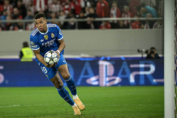 Olympiacos vs Real Madrid Review: Kylian Mbappe grabs the ball after scoring his first goal of the game during the UEFA Champions League 2025/26 League Phase MD5 match between Olympiacos and Real Madrid at the Georgios Karaiskakis Stadium on November 26, 2025.