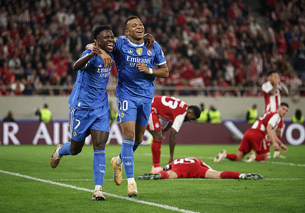 Olympiacos vs Real Madrid Review: Kylian Mbappe celebrates his fourth goal of the game with Vinicius Junior during the UEFA Champions League 2025/26 League Phase MD5 match between Olympiacos and Real Madrid at the Georgios Karaiskakis Stadium on November 26, 2025.