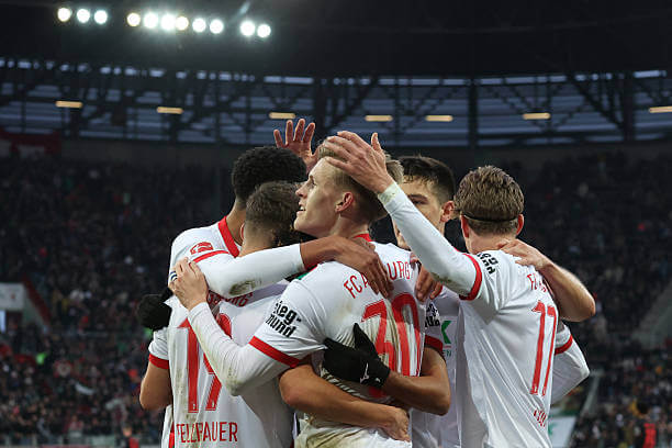 Bundesliga Roundup, Matchday 13: Anton Kade celebrates his goal with his teammates during the Bundesliga match between Augsburg and Bayer Leverkusen on December 6, 2025.