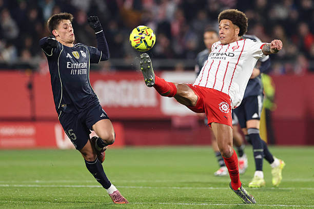 Girona vs Real Madrid Review: Arda Guler fights for the ball with Axel Witsel during the La Liga match between Girona and Real Madrid at the Montilivi Stadium on November 30, 2025.