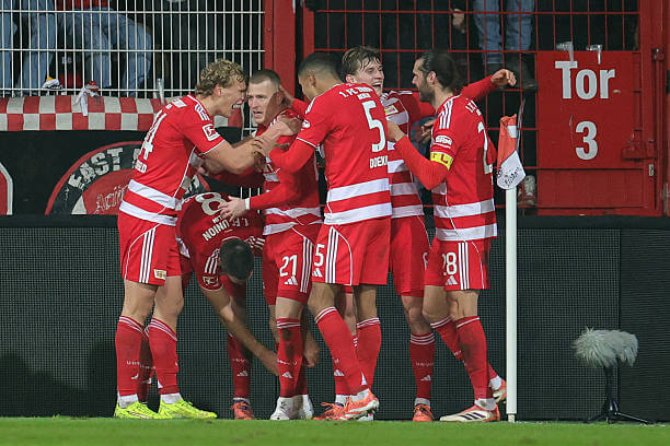 Bundesliga Roundup, Matchday 14: Tim Skarke celebrates his goal with his teammates during the Bundesliga match between Union Berlin and RB Leipzig at Stadion An der Alten Foersterei on December 12, 2025.