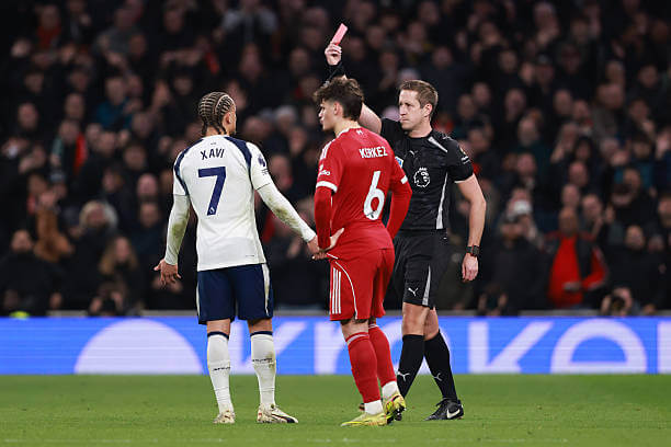 Tottenham vs Liverpool Review: Referee John Brooks shows a red card to Xavi Simons during the Premier League match between Tottenham and Liverpool at the Tottenham Hotspur Stadium on December 20, 2025.